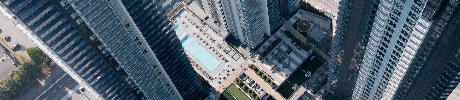 Aerial view of Gilmore Place residential towers, amenities, and SkyTrain station